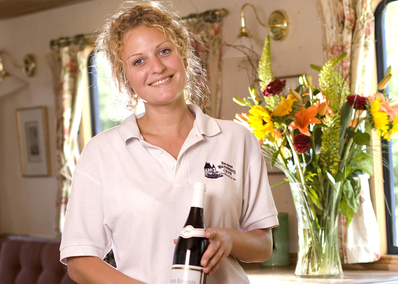 A European Waterways hostess serving a fine French wines onboard