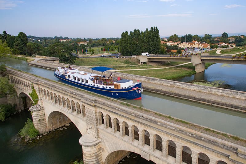 Hotel barge Anjodi crossing an aqueduct in the Canal du Midi