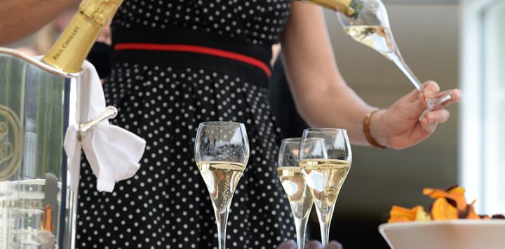 Champagne being poured into a flute glass