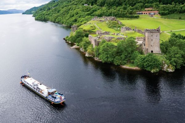 Highlander Barge cruises past Urquhart Castle -barge cruise europe