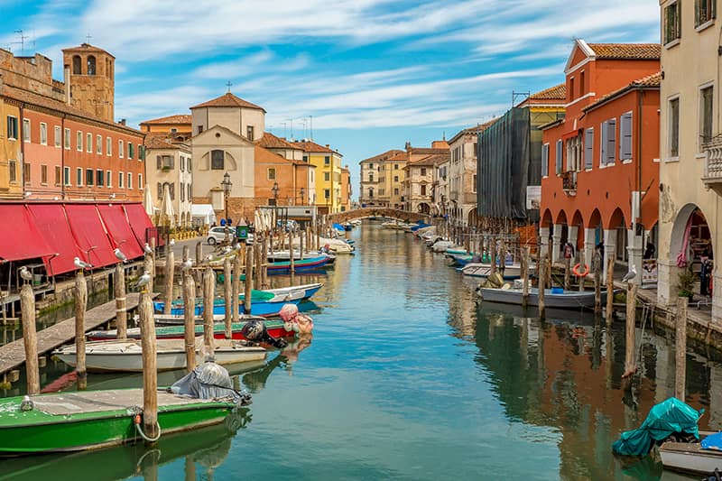 Small boats along the canal in the Italian city of Chioggia