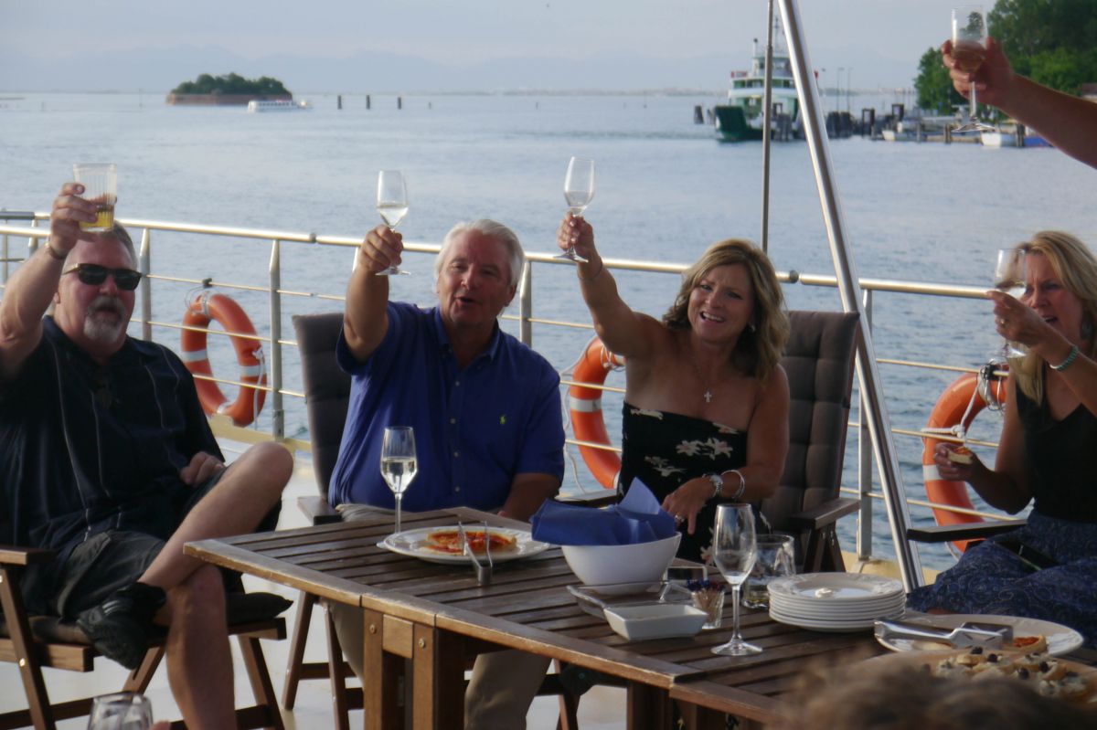 New friends toasting the day aboard luxury cruise La Bella Vita in Italy