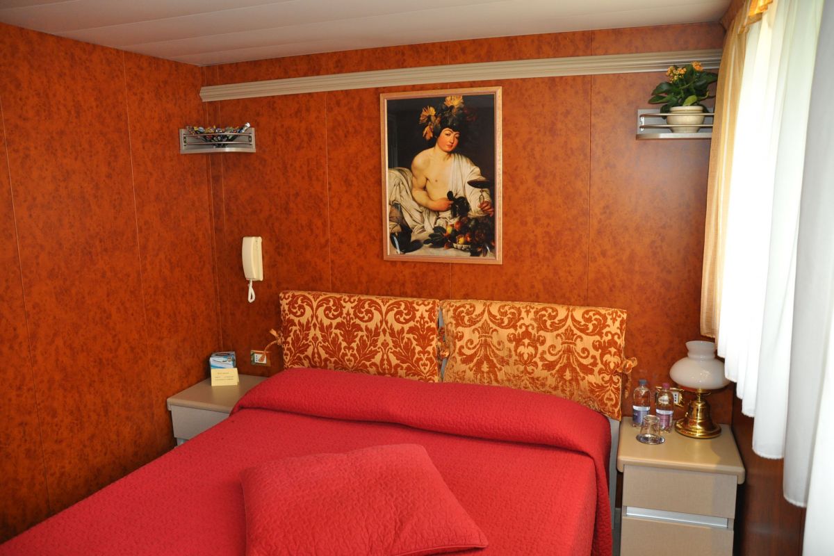 Spacious cabin equipped with a double bed onboard luxury hotel cruise, La Bella Vita