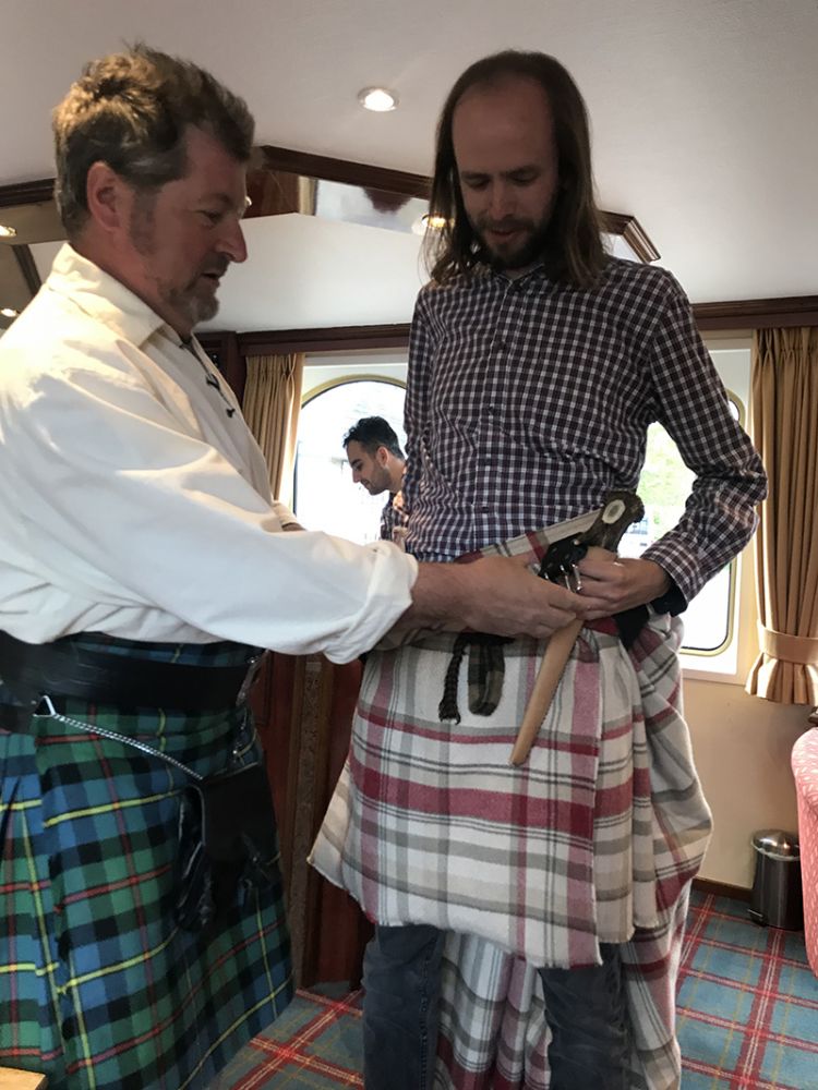 Scottish Highlander Ian Mackinnion shows how to wear a kilt