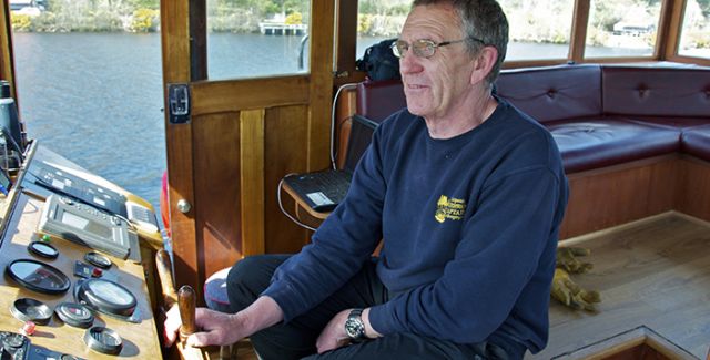 Scottish Highlander barge Captain, Mick Forster in the wheelhouse