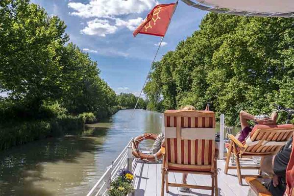 Clients relaxing on deck aboard luxury hotel barge, Athos