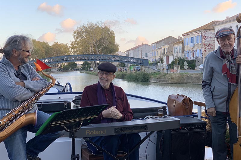 Jazz Trio aboard Anjodi with a foot bridge designed by Gustave Eiffel in the background by Judi Cohen