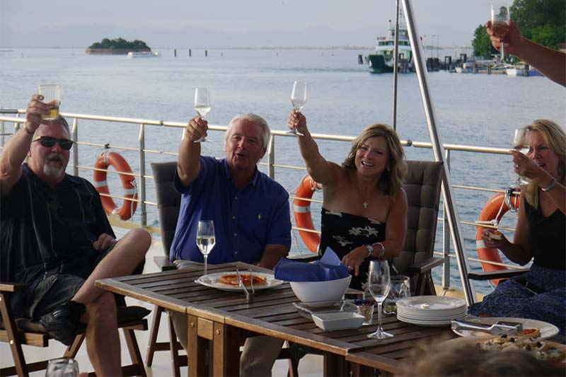 Hotel barge La Bella Via guests enjoying an aperitif on deck