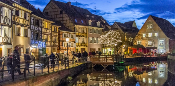 Christmas market cruises showcase traditional holiday season feelings with lit medieval houses, decorated trees and snow falling on the canals.