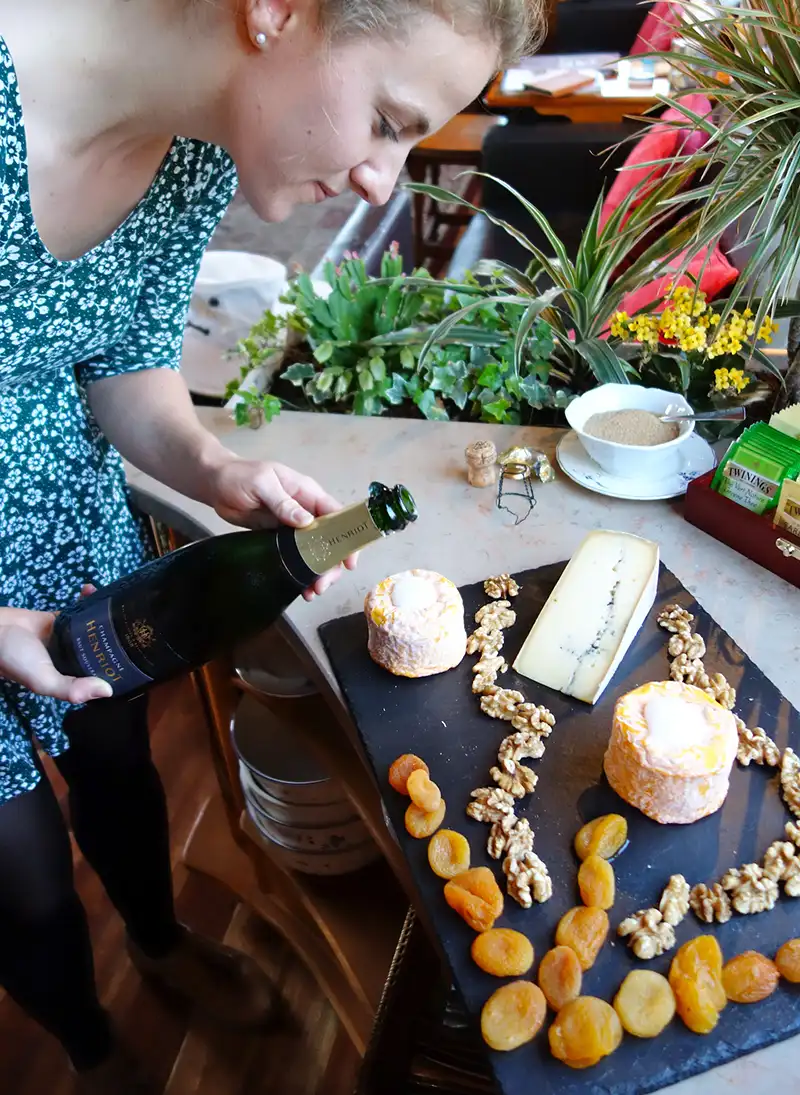 European Waterways host serving cheese and wine to guests on board