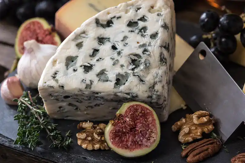 Roquefort served on a cheese board with figs and walnuts Roquefort served on a cheese board with figs and walnuts