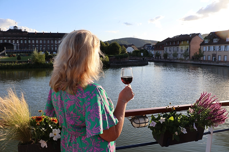 Relaxing on deck with a glass of wine by Jo Castro