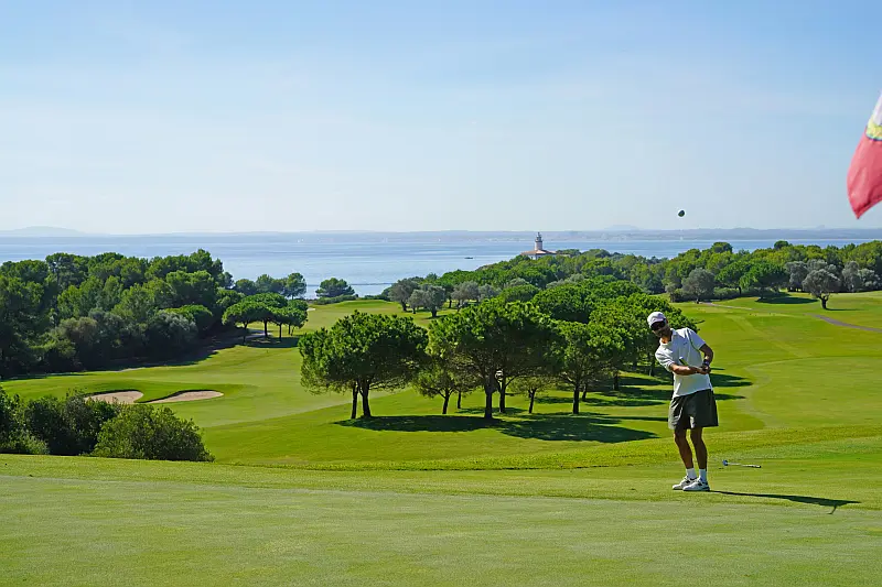 Person playing golf with ocean in background